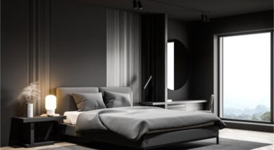 Gray bedroom corner with table lamp
